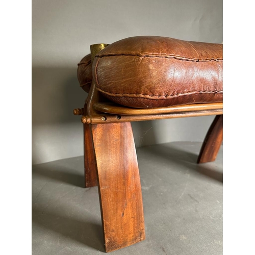 88 - A middle Eastern camel stool with brown leather seat on a hardwood and brass frame