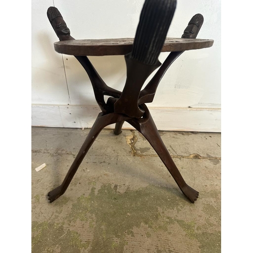 93 - A carved African tripod coffee table (H45cm Dia50cm)