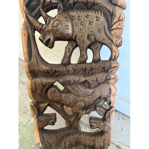 96 - A carved African birthing chair with elephant and rhino detail