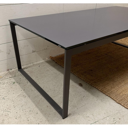 101 - A grey rectangular coffee table on a wrought iron painted base with glass top