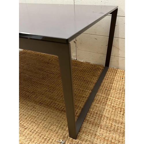 101 - A grey rectangular coffee table on a wrought iron painted base with glass top