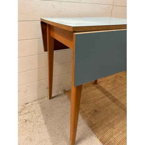 113 - A Mid Century drop leaf kitchen table with pale blue top (H76cm W60cm D51cm)