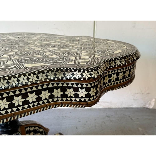 121 - A Moroccan style low pedestal table on splayed legs with geometrical mother of pearl and ebony inlay... 