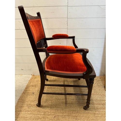 122 - A pair of salon chairs with satinwood inlay on castors.