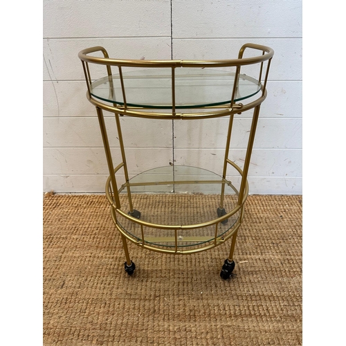 13 - A glass and brass effect drinks trolly with galleried top (H60cm Dia38cm)