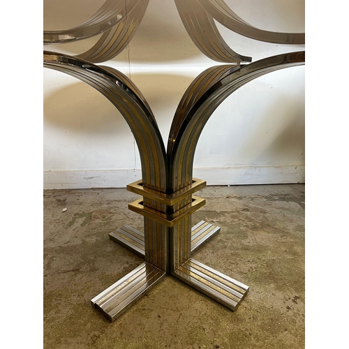 131 - A vintage circular glass dining table on a chrome base and brass by Banci and Fireaze (H72cm Dia130c... 