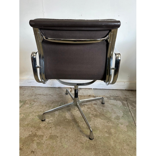 132 - A Vitra Eames soft pad chair with brown leather and chrome open arms