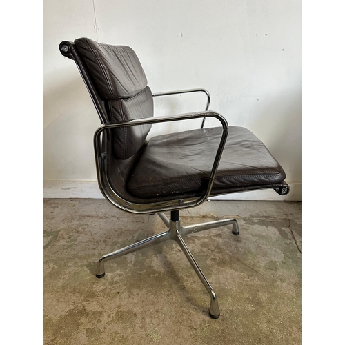 132 - A Vitra Eames soft pad chair with brown leather and chrome open arms