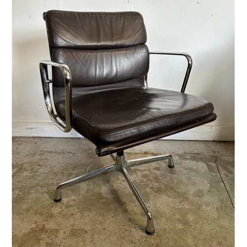 132 - A Vitra Eames soft pad chair with brown leather and chrome open arms