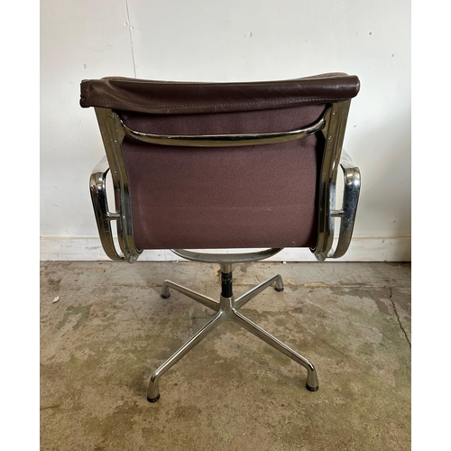 133 - A Vitra Eames soft pad chair with brown leather and chrome open arms