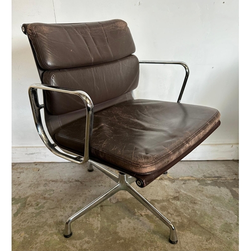 133 - A Vitra Eames soft pad chair with brown leather and chrome open arms