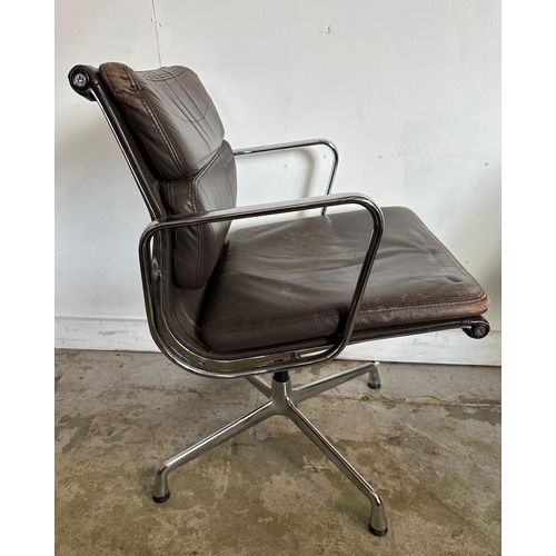 133 - A Vitra Eames soft pad chair with brown leather and chrome open arms