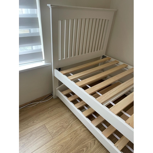 152 - A single white painted bed with another bed that slides under