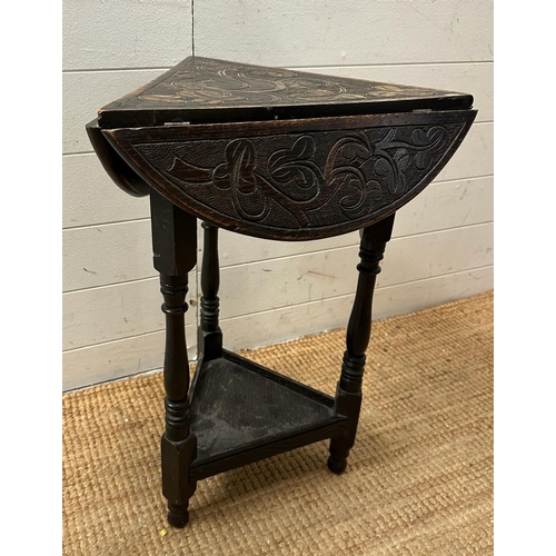 163 - An oak Arts and Crafts style drop leaf tripod side table (H62cm Dia40cm)