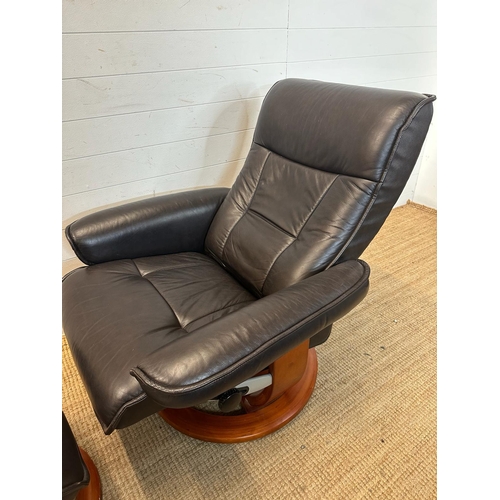 165 - A black leather ergonomic stressless arm chair and matching foot stool