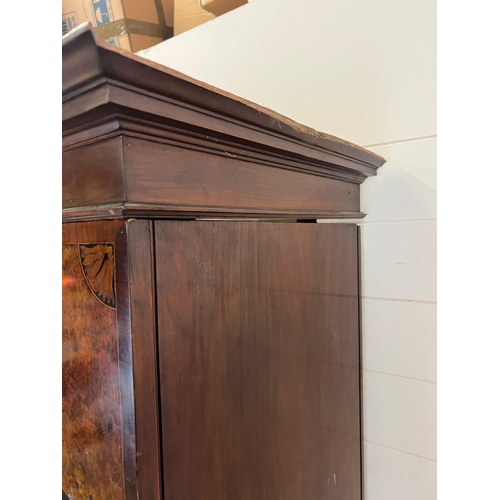 199 - A Victorian mahogany wardrobe with arched hood, the panelled inlaid sides with centre mirrored doors... 