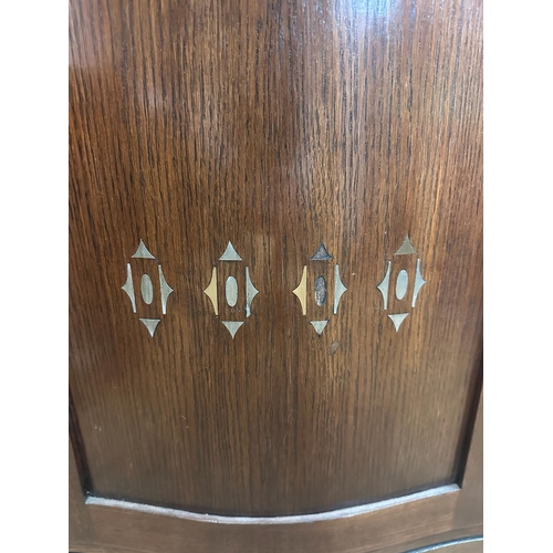 209 - An oak Art Deco cabinet comprising of two drawers four glazed cupboards and central mirror