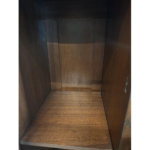 209 - An oak Art Deco cabinet comprising of two drawers four glazed cupboards and central mirror