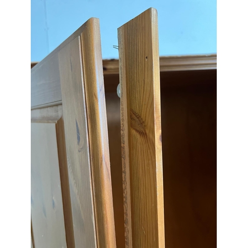 213 - A pine double wardrobe by Ducal (H192cm W98cm D61cm)