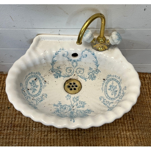 221 - A French porcelain hung clock room basin with blue floral decoration (37cm x 30cm