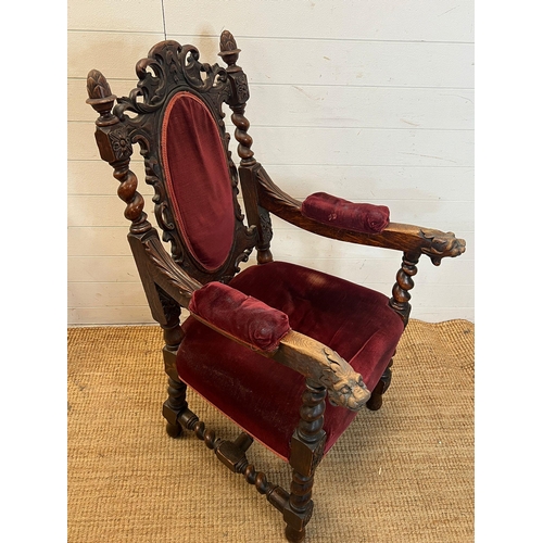 222 - A heavy carved green man oak chair with velvet upholstery seat and back