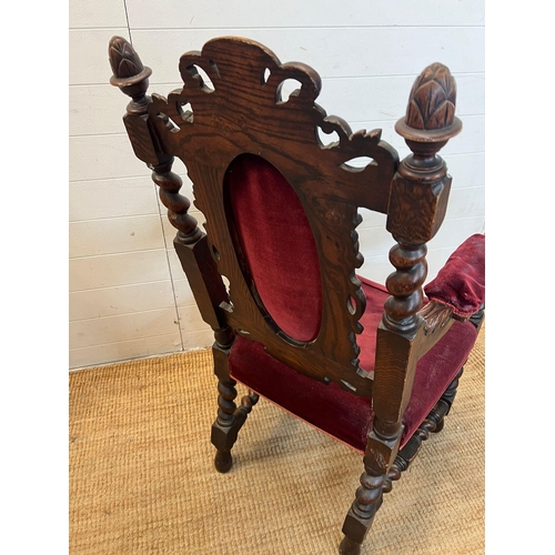 222 - A heavy carved green man oak chair with velvet upholstery seat and back