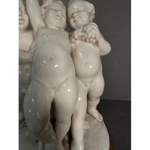 236 - A white ceramic figural cherub table lamp on gold painted base