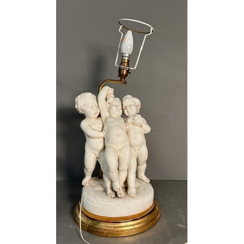 236 - A white ceramic figural cherub table lamp on gold painted base