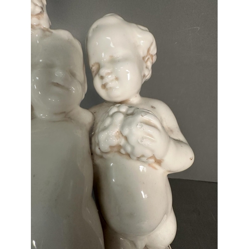 236 - A white ceramic figural cherub table lamp on gold painted base