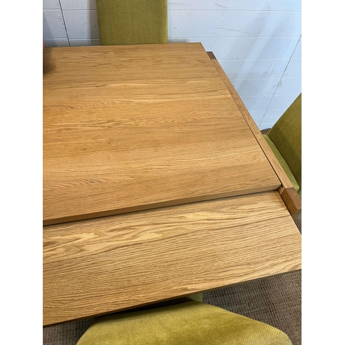 25 - A light oak dining table and four lime green chairs (H75cm Sq85cm)