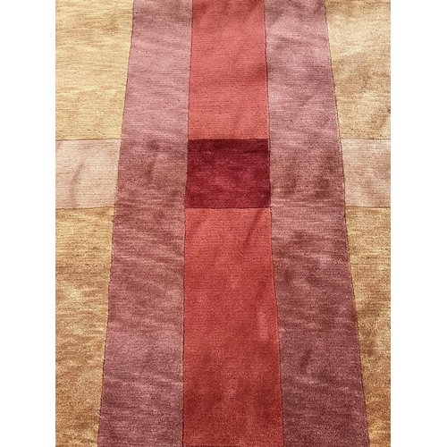 252 - A beige ground wool rug in red, brown and orange 300cm x 210cm