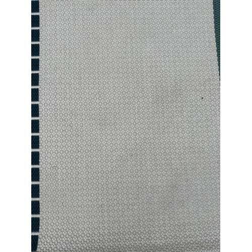 253 - A contemporary rug in blue, green and beige 200cm x 250cm