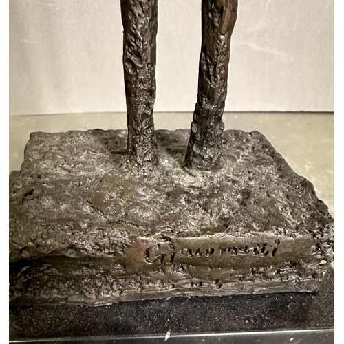 263 - A bronze sculpture of The Tall Man in a marble plinth and signed Giacometti to base