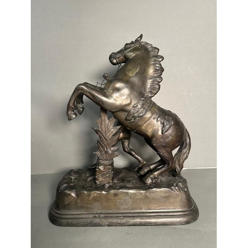 265 - A pair of metal  sculpture of tribal figures wrangling rearing horses Height approximately 40cm