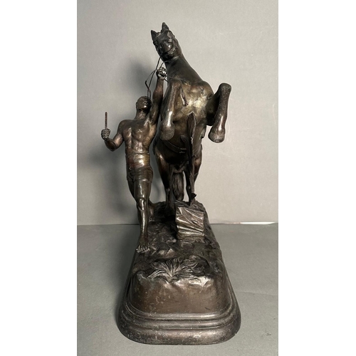 265 - A pair of metal  sculpture of tribal figures wrangling rearing horses Height approximately 40cm