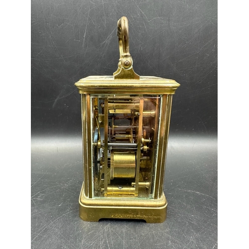 271 - A French brass cased carriage clock with glass panes to side and back