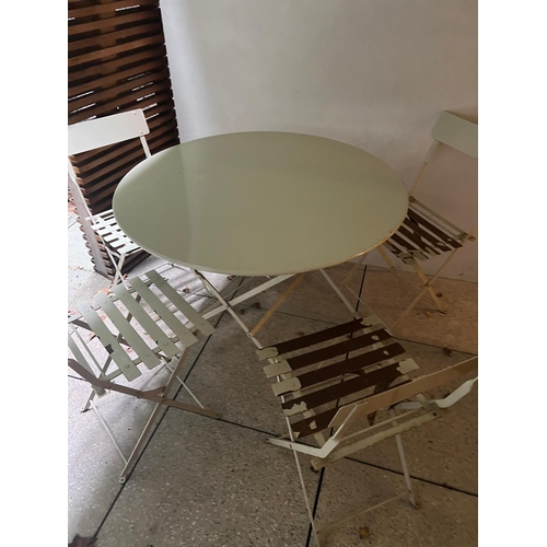 278 - A metal bistro set comprising of a table and four folding chairs (H74cm Dia97cm)