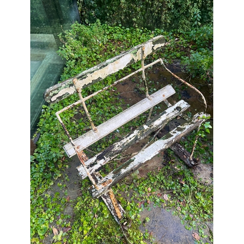 286 - An antique iron garden bench with wooden slats to seat and base (H76cm W81cm D52cm SH43cm)