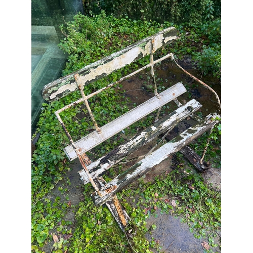 286 - An antique iron garden bench with wooden slats to seat and base (H76cm W81cm D52cm SH43cm)