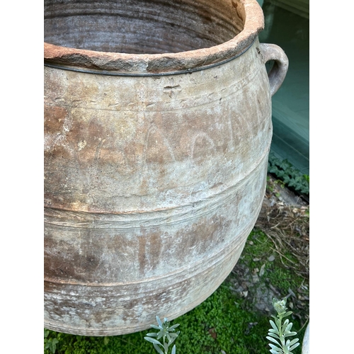 288 - A large olive pitcher terracotta urn with three handles AF (H102cm Dia58cm)