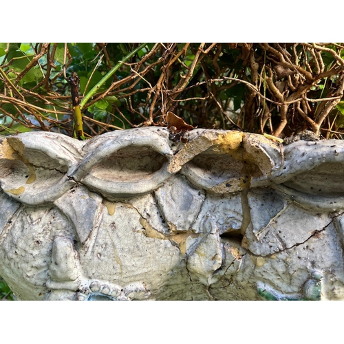 289 - A glazed ceramic planter with platted design around the top and natural scene including a clock in a... 