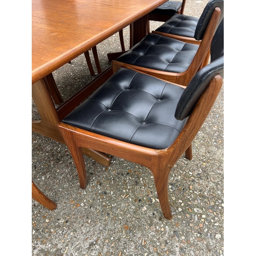 3 - An extending teak dining table by Vanson along with the Vanson for Heals eight chairs whit black pos... 