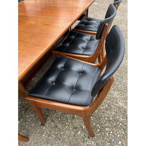 3 - An extending teak dining table by Vanson along with the Vanson for Heals eight chairs whit black pos... 