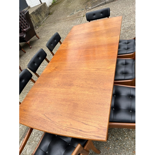 3 - An extending teak dining table by Vanson along with the Vanson for Heals eight chairs whit black pos... 