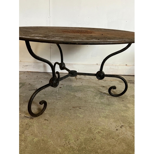 303 - A French style round decorative garden table with scrolling iron work legs (H54cm Dia100cm)