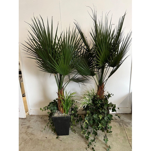 306 - A pair of large artificial palm in a black planter (pot H38cm, total H180cm)