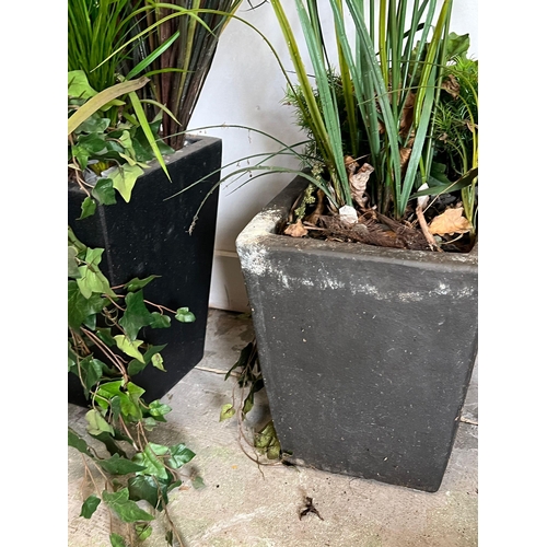 307 - Two planters with artificial plants (H34cm and H37cm)