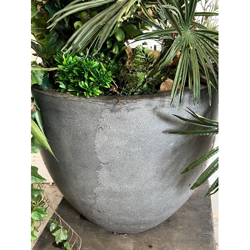 311 - A large copper style planter with artificial palms and ivy