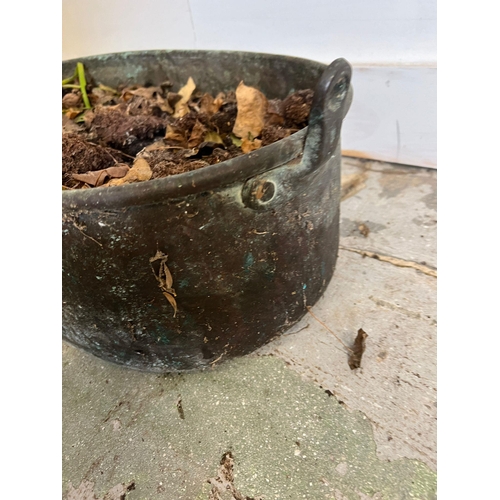 320 - A weathered copper pan used as a planter (H20cm W60cm)