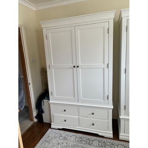 36 - A white two door wardrobe with four drawers below and hanging space above (H200cm W114cm D55cm)